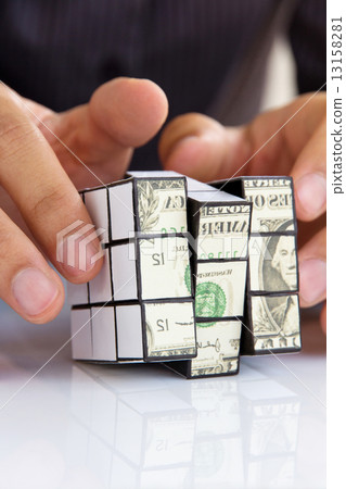 hand holding a rubik's cube,money concept hand holding a rubik's cube,money concept 13158281