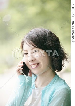 A woman carrying a mobile phone 13159017
