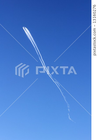 An airplane quietly advancing to flow far above the sky while drawing an airborne cloud 13160276
