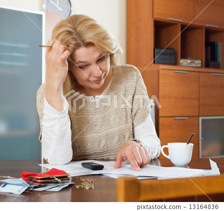 Serious blonde woman thinking 13164836