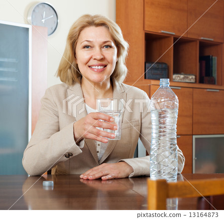 mature woman drinking water 13164873