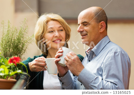 Couple drinking coffee at balcony Couple drinking coffee at balcony 13165025