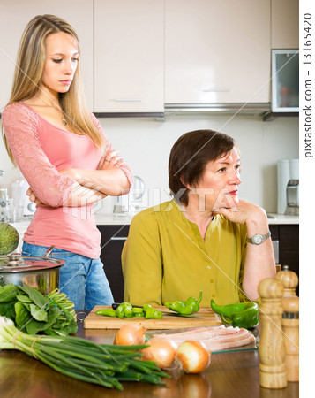mother and daughter having quarrel 13165420