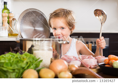 Little girl cooking soup 13165427