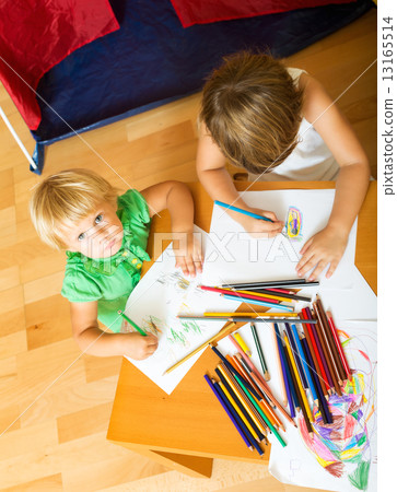 Siblings playing with pencils 13165514