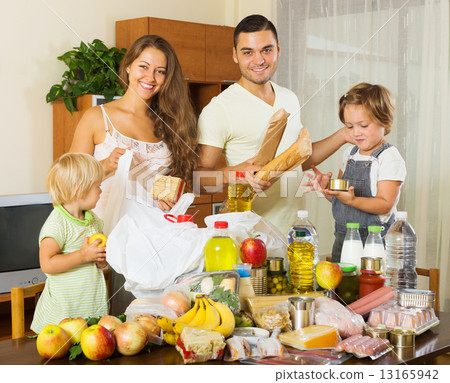 Cheerful family with bags of food Cheerful family with bags of food 13165942