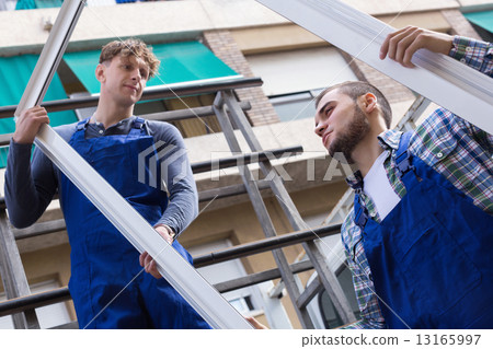 Two workmen delivering PVC profiles 13165997