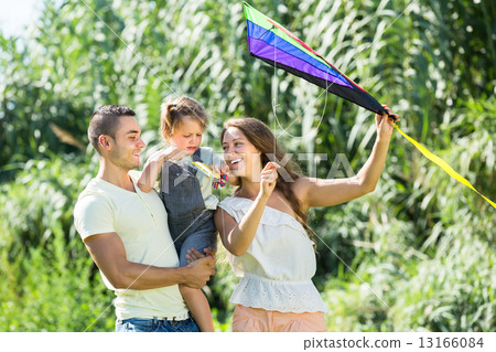 Family with toy kite at park 13166084