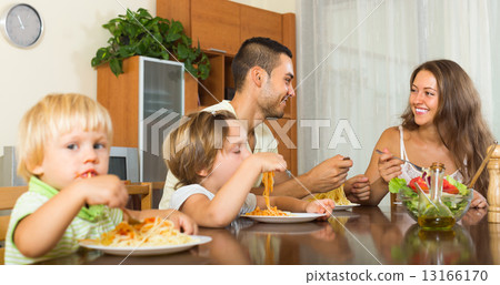 Family of four eating spaghetti 13166170