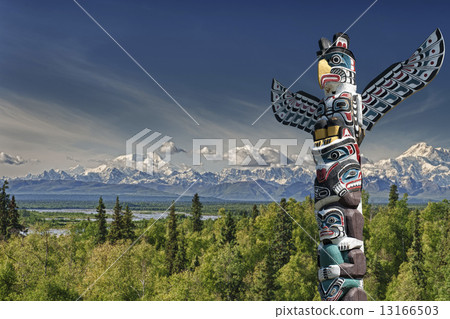 A totem wood pole in mountain background 13166503