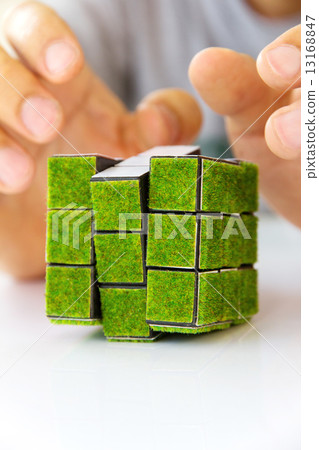 hand holding green rubik's cube concept  13168847