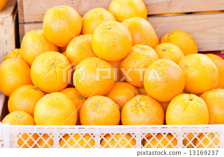 Orange fruit in plastic crate. 13169237