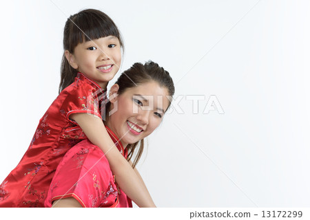 Young Chinese mother in cheongsam piggyback daughter isolated white background 13172299