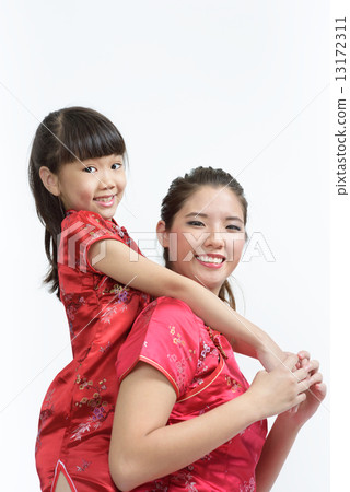 Young Chinese mother in cheongsam piggyback daughter isolated white background 13172311