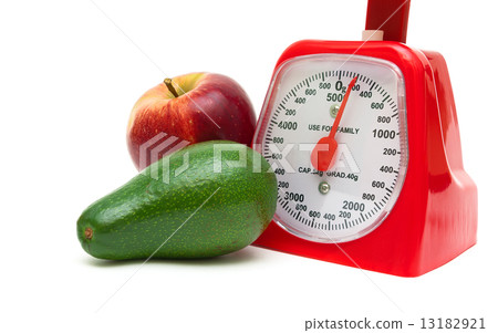 avocado, apple and kitchen scales isolated on white background 13182921