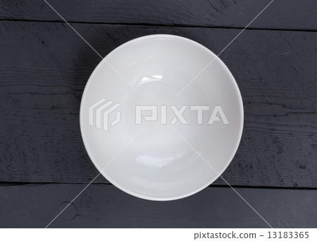 Empty bowl on a black wooden bird's eye view 13183365