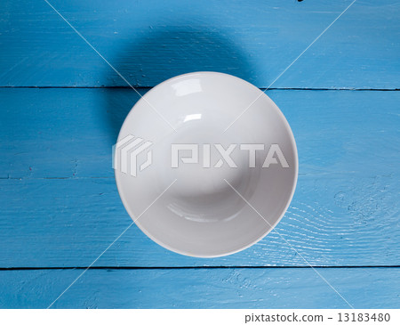 Empty bowl on blue wooden bird's eye view Empty bowl on blue wooden bird's eye view 13183480