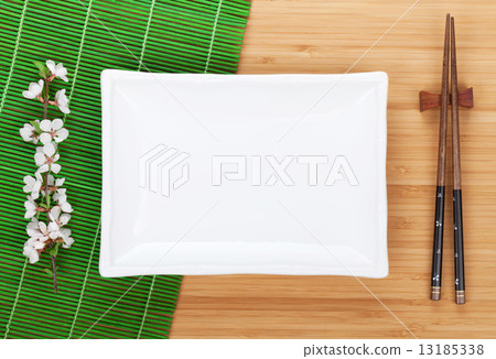 Empty plate, chopsticks and sakura branch 13185338