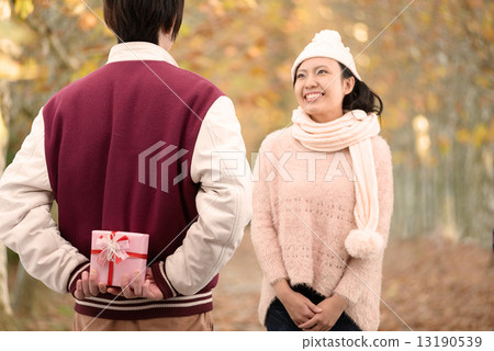 Young lovers who date on autumn tree-lined streets 13190539