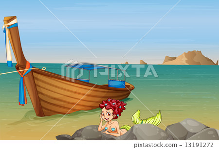 A mermaid at the sea near the wooden boat A mermaid at the sea near the wooden boat 13191272