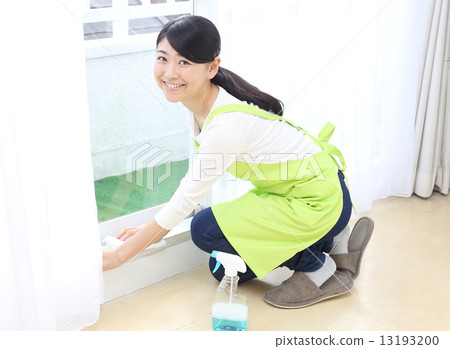 A woman wiping a window frame A woman wiping a window frame 13193200