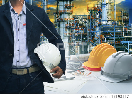 engineering man standing with white safety helmet against oil r engineering man standing with white safety helmet against oil r 13198117