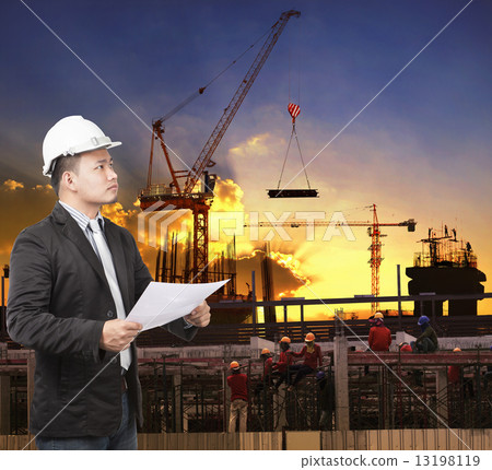 young engineer man working with construction plan in building st young engineer man working with construction plan in building st 13198119
