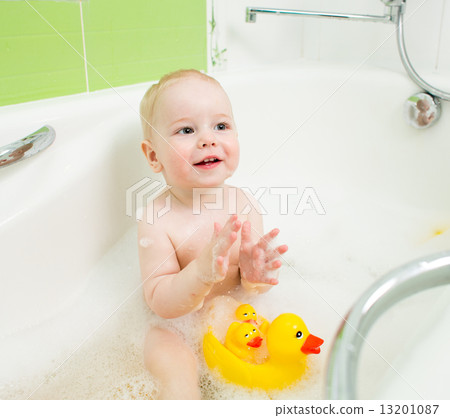 baby boy clapping hands and smiling while taking a bath baby boy clapping hands and smiling while taking a bath 13201087