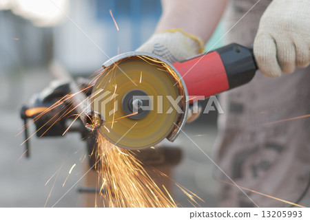 Worker cuts metal. Worker cuts metal. 13205993