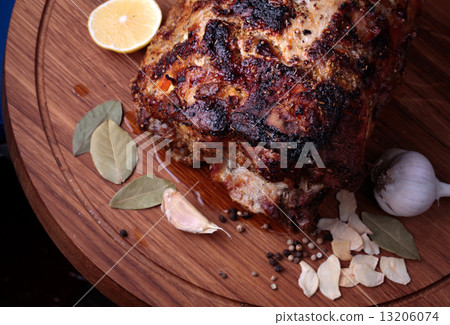Roasted meat on wooden cutting board closeup 13206074