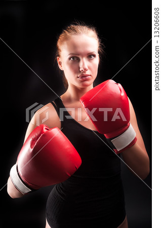 Beautiful girl defends in boxing gloves Beautiful girl defends in boxing gloves 13206608
