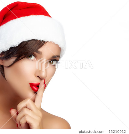 Christmas Girl in Santa Hat doing a Hush Sign 13210912