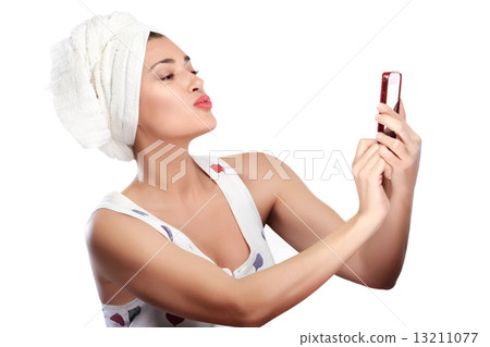 Beautiful Young woman after shower makes selfie sending a kiss 13211077