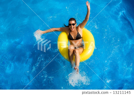 Aquapark. Beauty Brunette Playing in the Pool 13211145