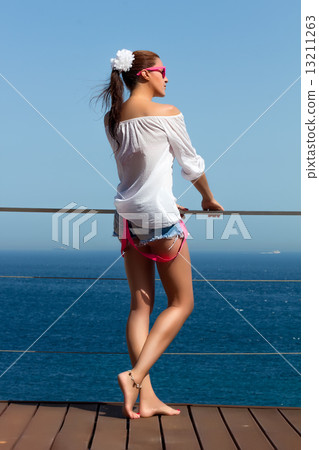 Backside of Fashionable Girl in Denim Shorts. Beauty Legs 13211263