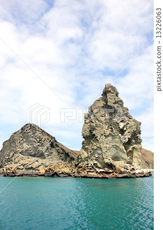 Island of biological evolution theory floating on the Pacific Ocean of South America Ecuador, Pinnacle of Bartolome Island floating off Santiago Island in the Galapagos Islands and a beautiful sea landscape 13226063