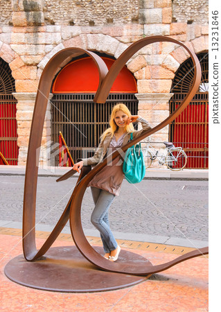 Attractive girl near sculptural composition "Forever Love"- " be Attractive girl near sculptural composition "Forever Love"- " be 13231846