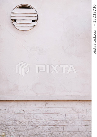 white brick wall with a hole for fan 13232730