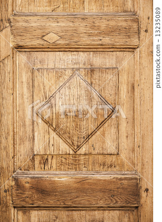 Old wooden decorative panel on the door 13235089