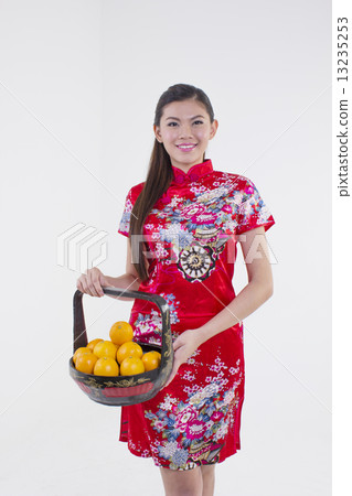 Girl with a basket of oranges 13235253