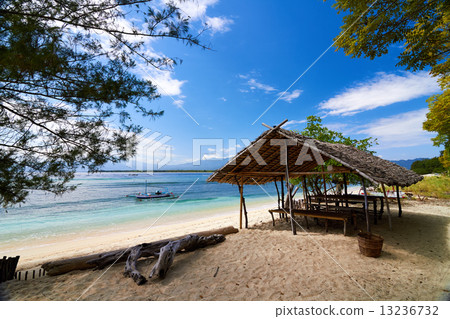 Traditional boat and bungalow on tropical beach Traditional boat and bungalow on tropical beach 13236732