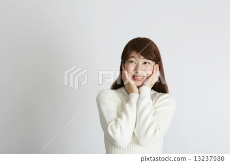 A young lady looking at the upper left with a smile A young lady looking at the upper left with a smile 13237980