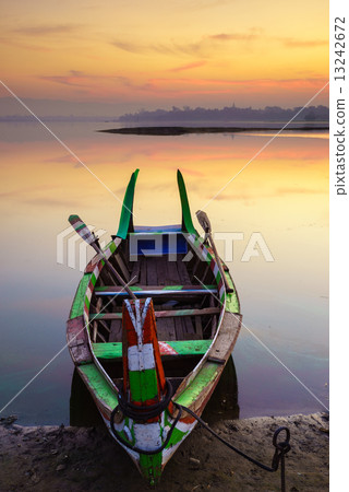 Wooden boat in Ubein Bridge at sunrise, Mandalay, Myanmar 13242672