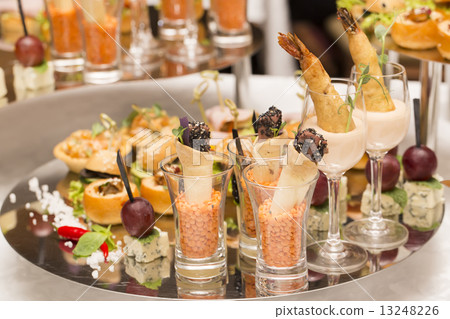 Canapes of cheese vegetables meat and seafood on white background 13248226