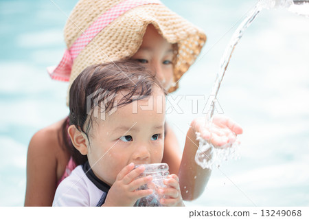 little child, playing in water, older sister and younger brother 13249068