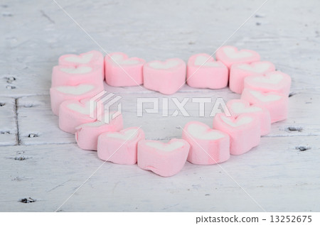 Pink heart shape mashmellow on wooden background. Pink heart shape mashmellow on wooden background. 13252675