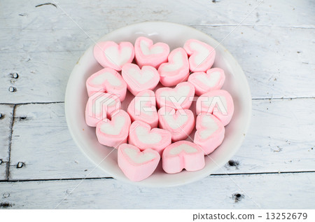 Pink heart shape mashmellow on wooden background. Pink heart shape mashmellow on wooden background. 13252679