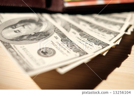 Brown Wallet with credit cards and dollar banknotes over wooden Brown Wallet with credit cards and dollar banknotes over wooden 13256104