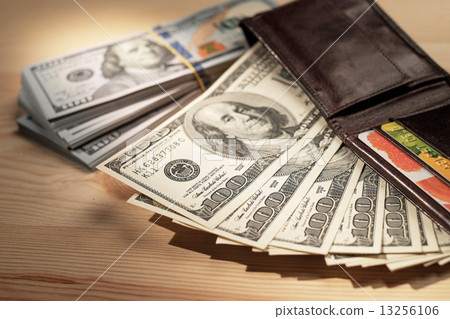 Brown Wallet with credit cards and dollar banknotes over wooden Brown Wallet with credit cards and dollar banknotes over wooden 13256106