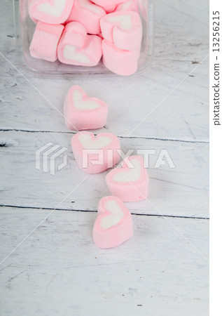 Pink heart shape mashmellow on wooden background. 13256215